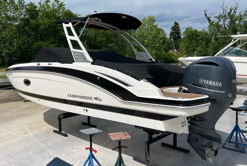Slide: The Image of 2016 Chaparral 250 Suncoast boat with Yamaha engine on stands, outdoors. - 2