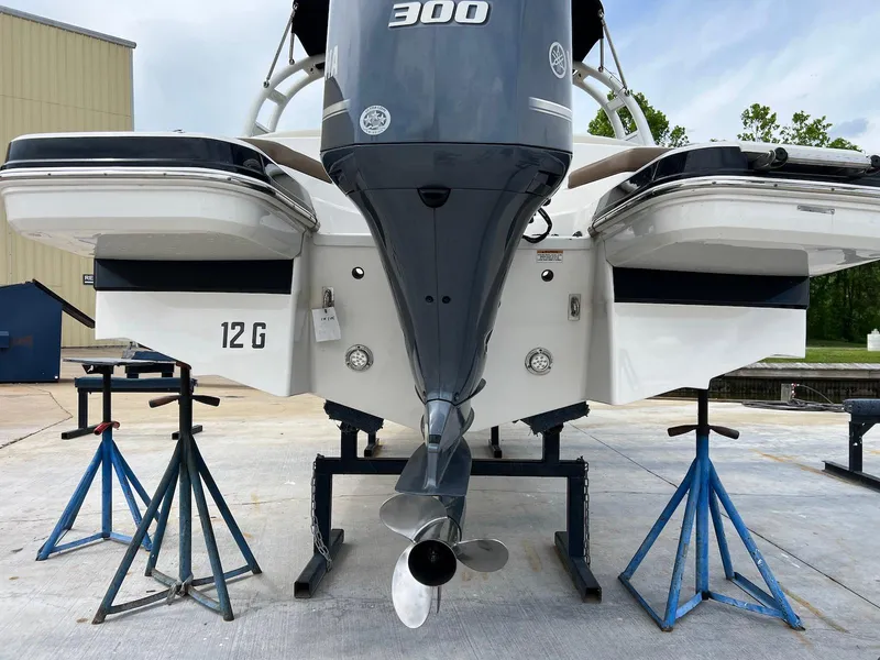 Slide: The Image of 2016 Chaparral 250 Suncoast boat on stands, rear view with outboard motor. - 22