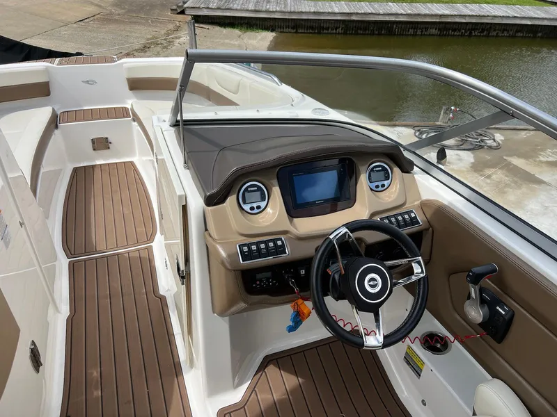 Slide: The Image of 2016 Chaparral 250 Suncoast boat interior with modern dashboard and steering wheel. - 5