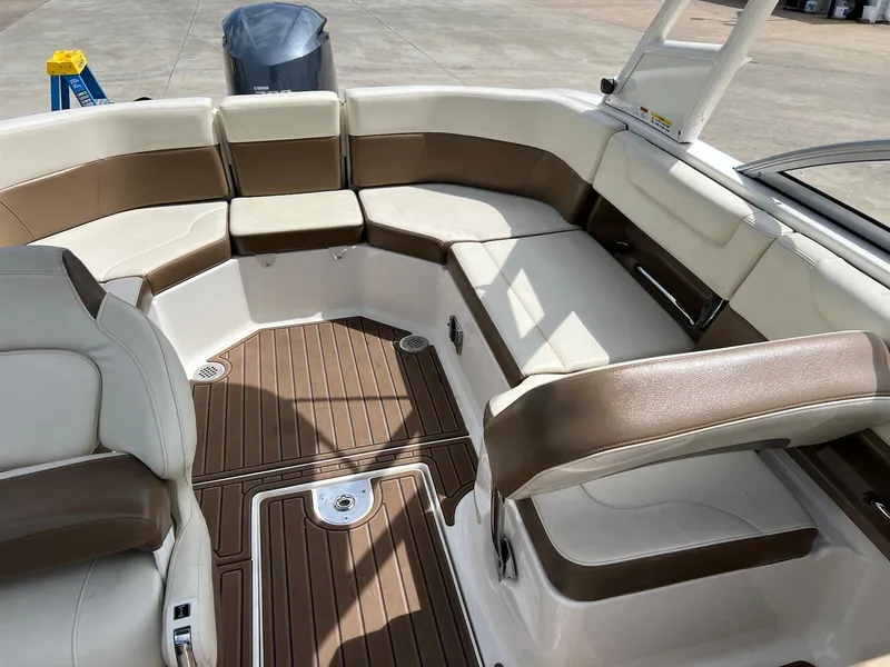 Slide: The Image of 2016 Chaparral 250 Suncoast boat interior with brown and white seating. - 8