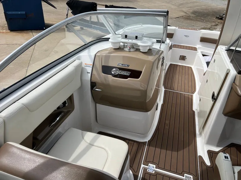 Slide: The Image of 2016 Chaparral 250 Suncoast boat interior with brown and white seating and dashboard. - 9
