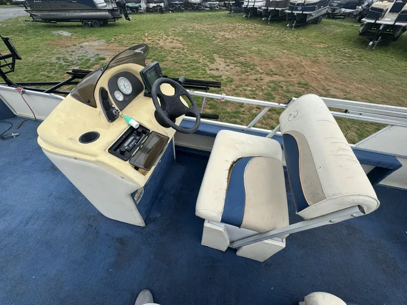 Slide: The Image of Interior of a 2000 Starcraft 200 Classic boat with steering console and seating. - 14