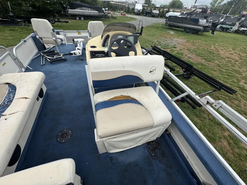 Slide: The Image of 2000 Starcraft 200 Classic boat interior with worn seating and blue carpet. - 18