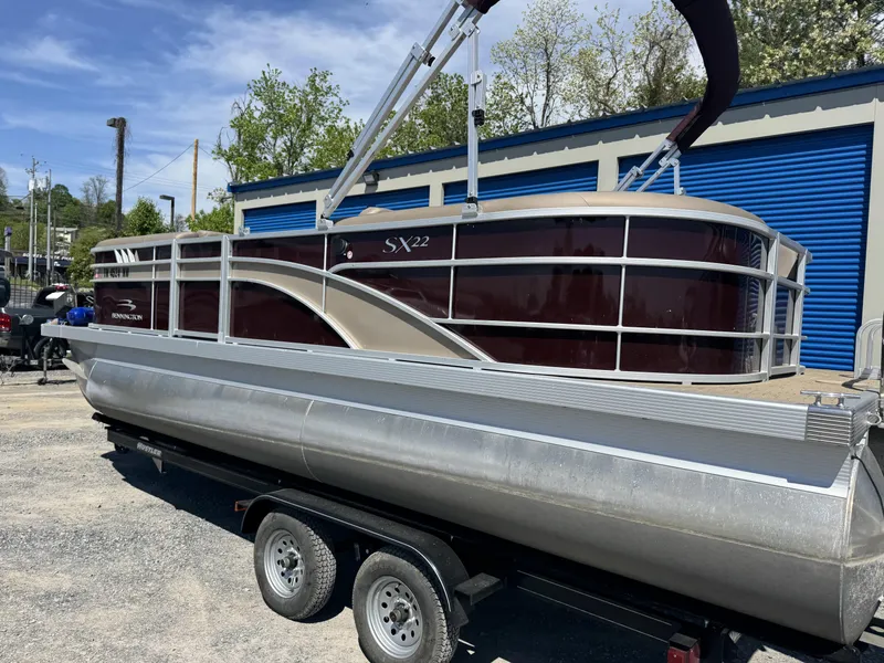 Slide: The Image of 2022 Bennington 22 SXSR pontoon boat on trailer, parked outdoors. - 15