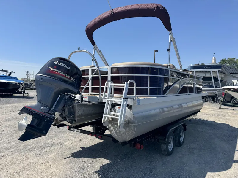 Slide: The Image of 2022 Bennington 22 SXSR pontoon boat with Yamaha outboard motor on trailer. - 17