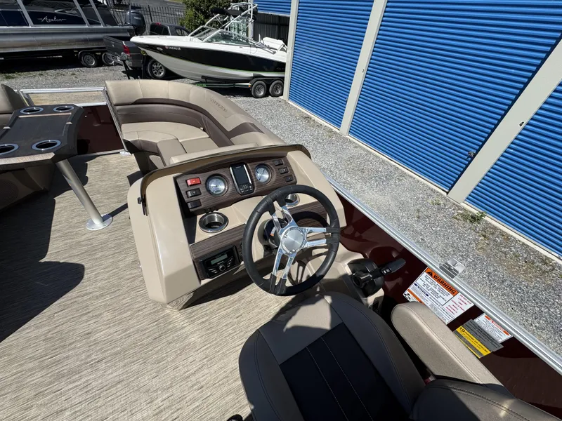 Slide: The Image of 2022 Bennington 22 SXSR boat interior with steering wheel and seating area. - 24