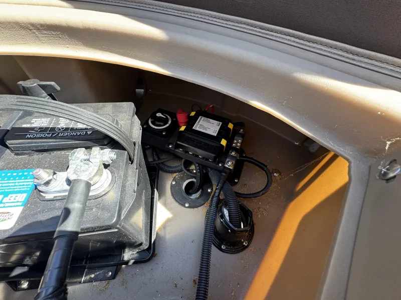 Slide: The Image of Battery compartment of 2022 Bennington 22 SXSR boat, showing wiring and connections. - 27