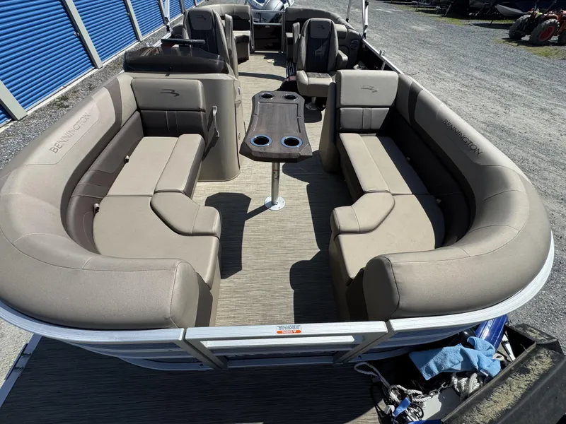 Slide: The Image of 2022 Bennington 22 SXSR pontoon boat with spacious seating and central table. - 6