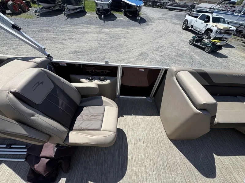 Slide: The Image of 2022 Bennington 22 SXSR boat interior with beige seating and cup holders. - 8
