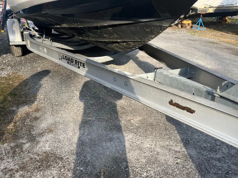 Slide: The Image of Boat trailer with a 2015 Monterey 264FSX, parked on gravel. - 13