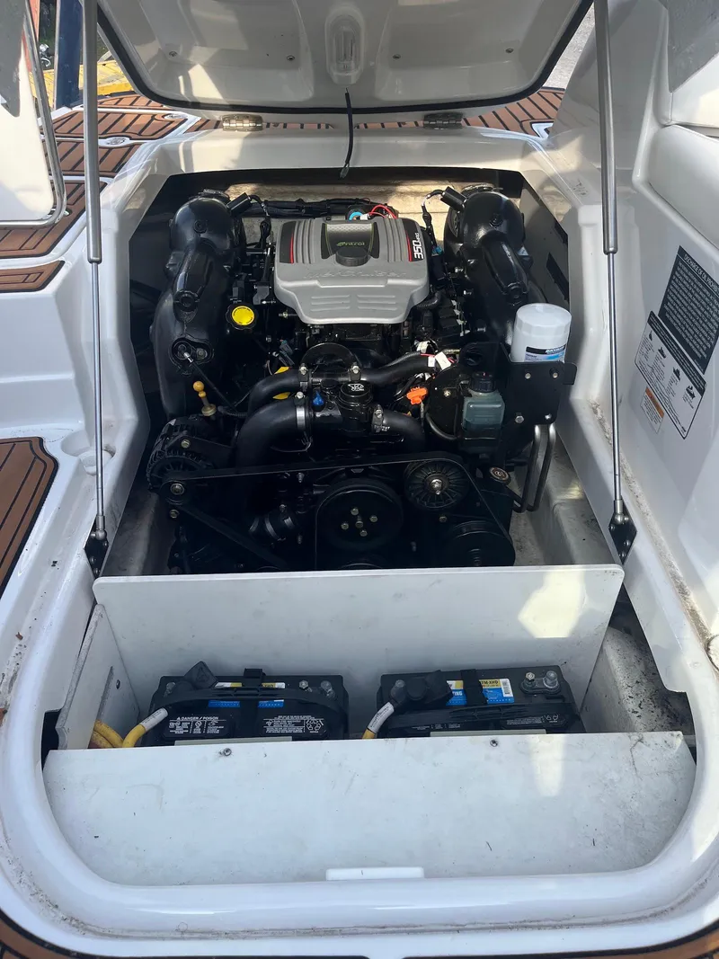 Slide: The Image of 2015 Monterey 264FSX boat engine compartment with visible components and batteries. - 14