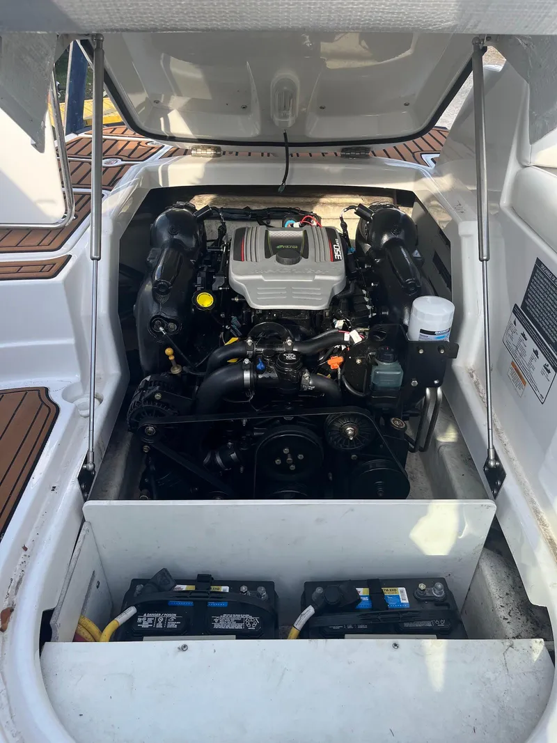 Slide: The Image of 2015 Monterey 264FSX boat engine compartment with visible batteries and components. - 15