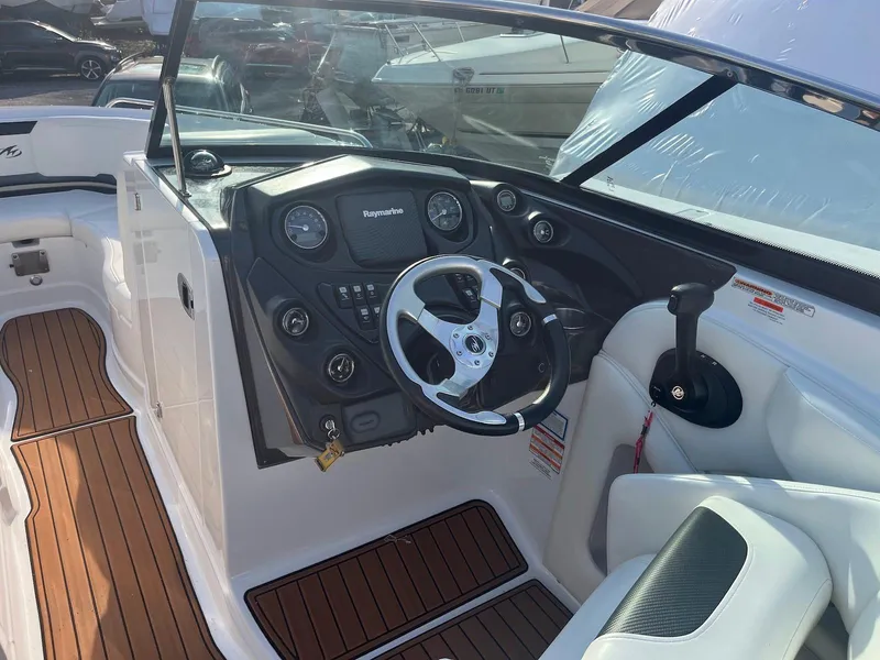 Slide: The Image of 2015 Monterey 264FSX boat cockpit with steering wheel and control panel. - 3