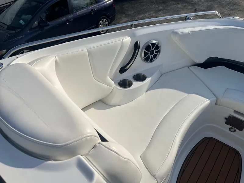 Slide: The Image of 2015 Monterey 264FSX boat interior with white seating, cup holders, and speaker. - 4