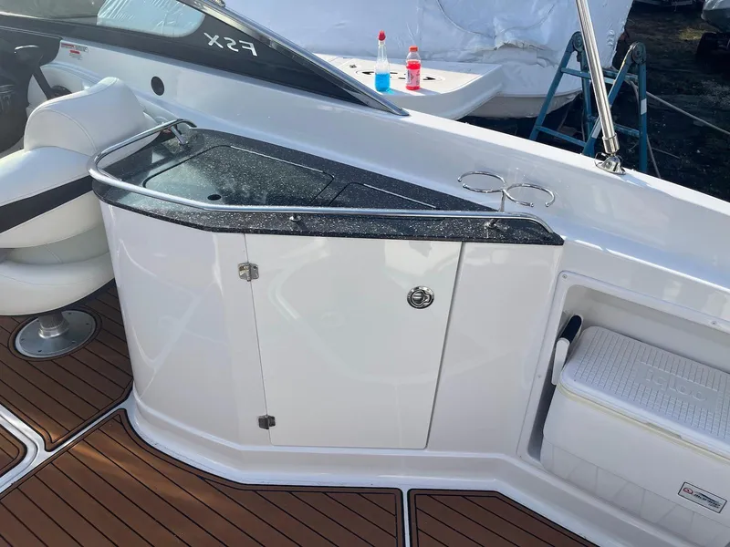 Slide: The Image of 2015 Monterey 264FSX boat interior with sleek countertop and storage cabinet. - 6