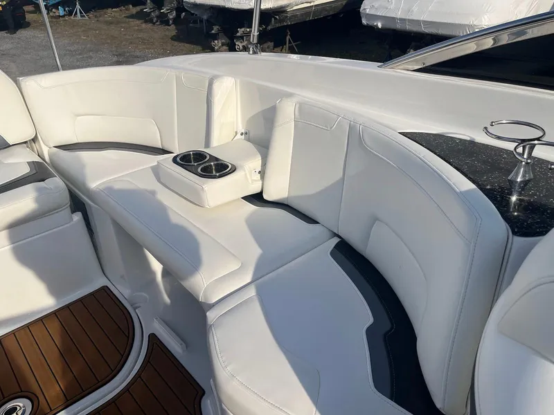 Slide: The Image of Luxurious seating area on a 2015 Monterey 264FSX boat with white upholstery and cup holders. - 7
