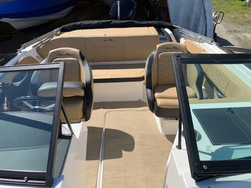 Slide: The Image of 2022 Sea Ray SPX 190 OB boat interior with tan seating and black trim. - 10
