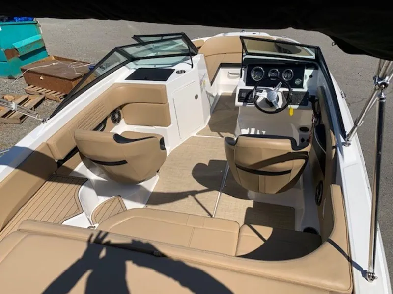 Slide: The Image of 2022 Sea Ray SPX 190 OB boat interior with tan seating and modern dashboard. - 6