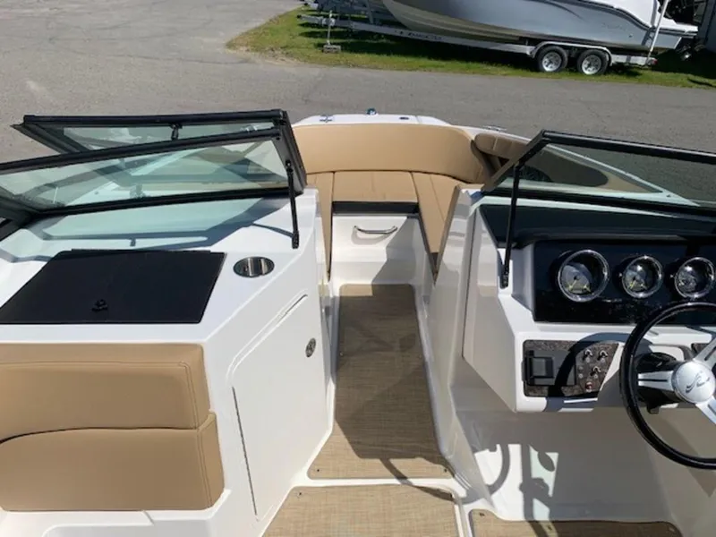 Slide: The Image of 2022 Sea Ray SPX 190 OB boat interior with tan seating and modern dashboard. - 7