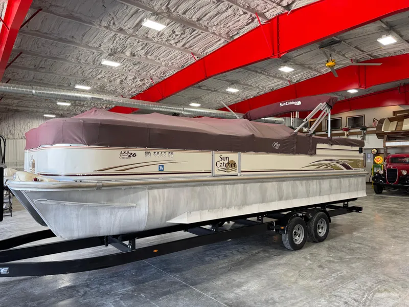 Slide: The Image of 2008 G3 LX 26C pontoon boat with cover on trailer in indoor storage. - 13