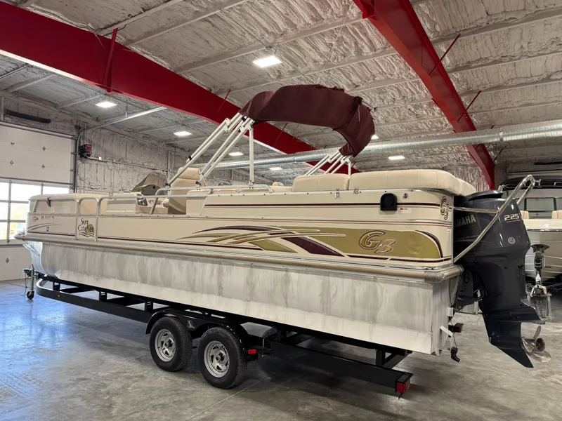 Slide: The Image of 2008 G3 LX 26C pontoon boat in indoor storage, featuring Yamaha outboard motor. - 3