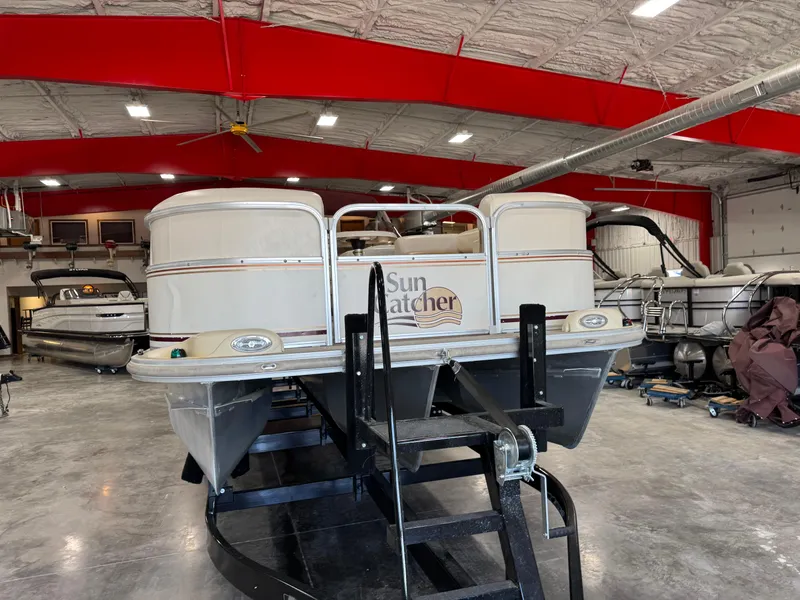 Slide: The Image of 2008 G3 LX 26C SunCatcher pontoon boat in a spacious indoor storage facility. - 4