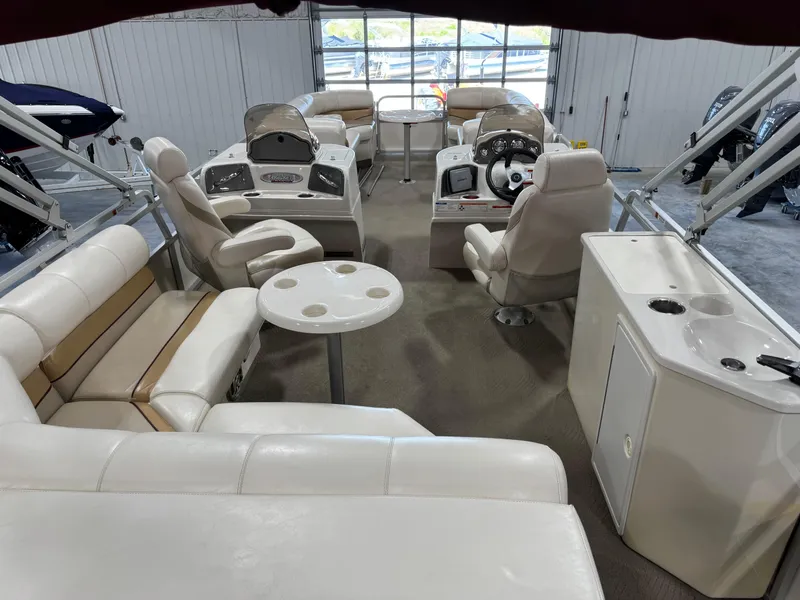 Slide: The Image of 2008 G3 LX 26C boat interior with white seating, steering console, and table. - 7