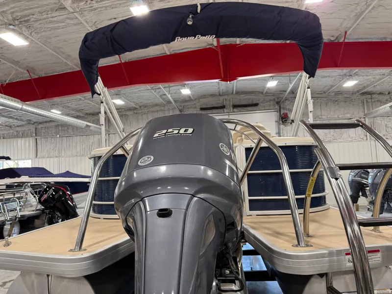 Slide: The Image of 2016 AquaPatio 220 AD pontoon boat with 250 HP engine in indoor storage. - 5