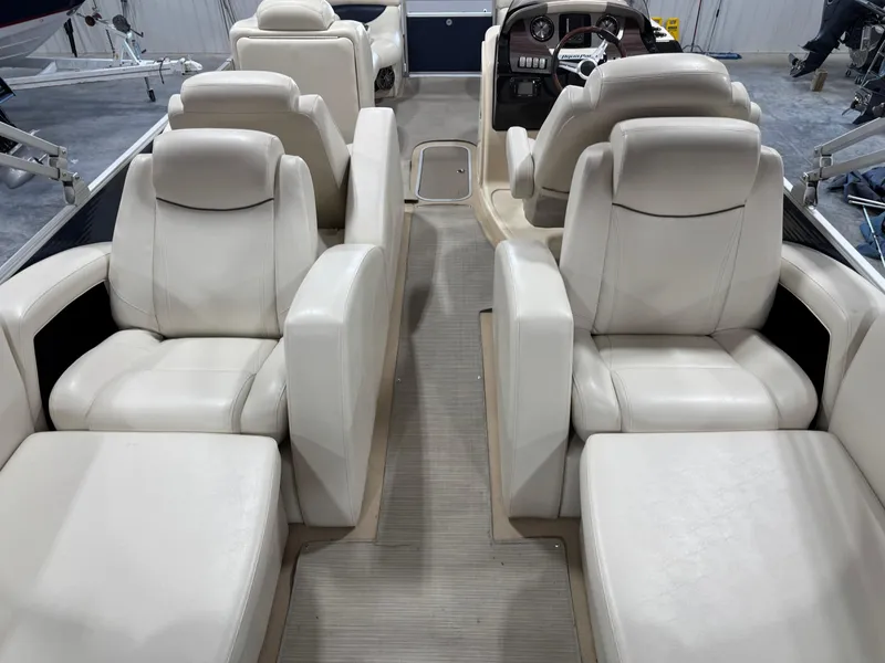Slide: The Image of Interior of 2016 AquaPatio 220 AD boat with luxurious white seating and helm. - 6