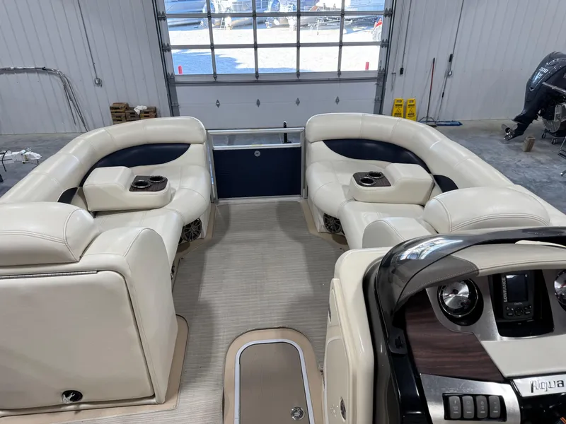 Slide: The Image of Interior of a 2016 AquaPatio 220 AD boat with plush seating and modern dashboard. - 7