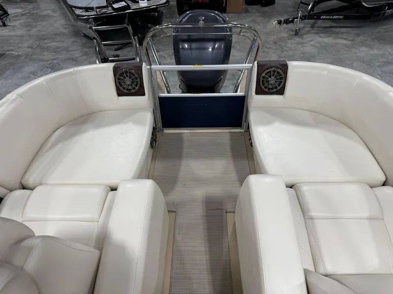 Slide: The Image of 2016 AquaPatio 220 AD boat interior with white seating and speakers. - 8