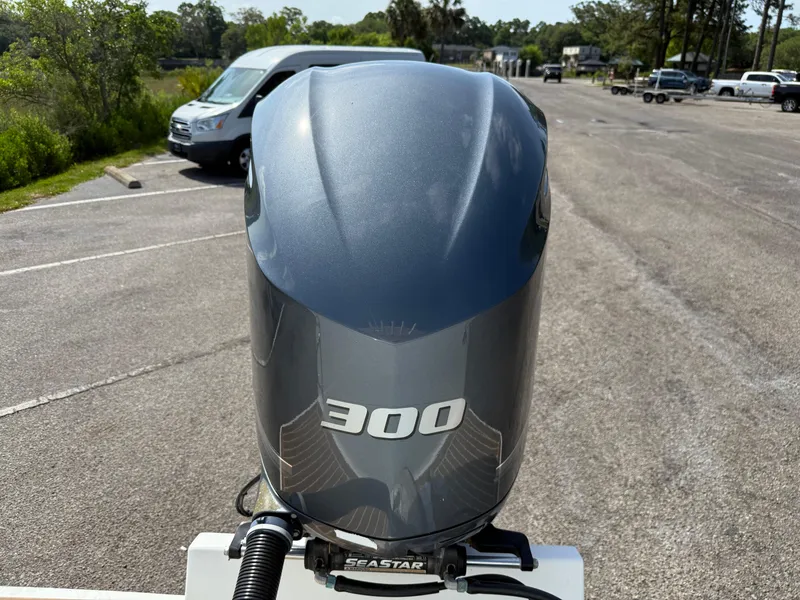 Slide: The Image of 2016 Regulator 23 boat with a 300 horsepower engine in a parking lot. - 10