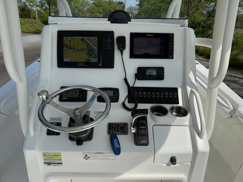 Slide: The Image of 2016 Regulator 23 boat console with navigation screens, steering wheel, and control panel. - 11