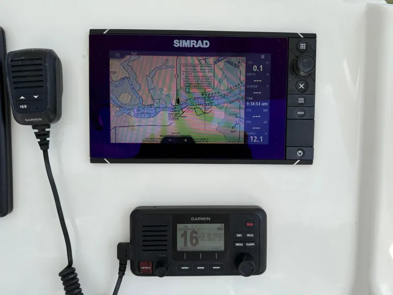 Slide: The Image of Simrad and Garmin navigation equipment on a 2016 Regulator 23 boat dashboard. - 13
