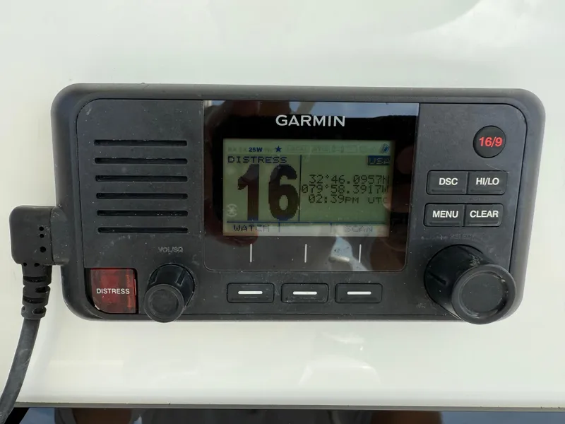 Slide: The Image of Garmin marine radio on 2016 Regulator 23 boat, displaying distress channel 16. - 14