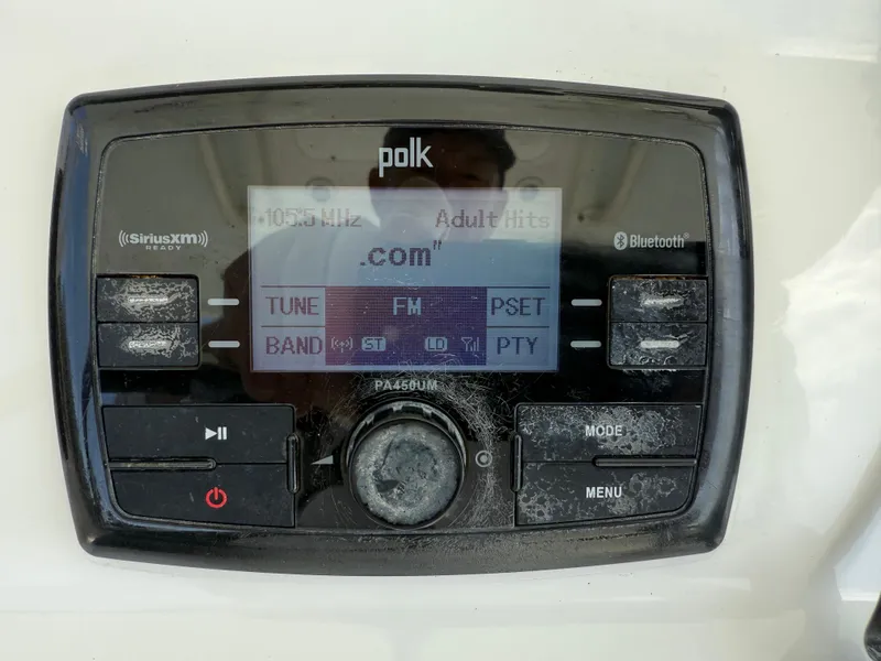 Slide: The Image of Polk audio system on 2016 Regulator 23 boat, featuring FM, Bluetooth, and SiriusXM options. - 16