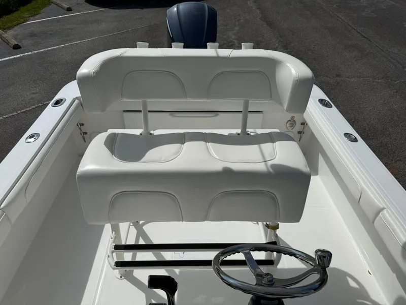 Slide: The Image of 2016 Regulator 23 boat interior with white seating and steering wheel. - 18