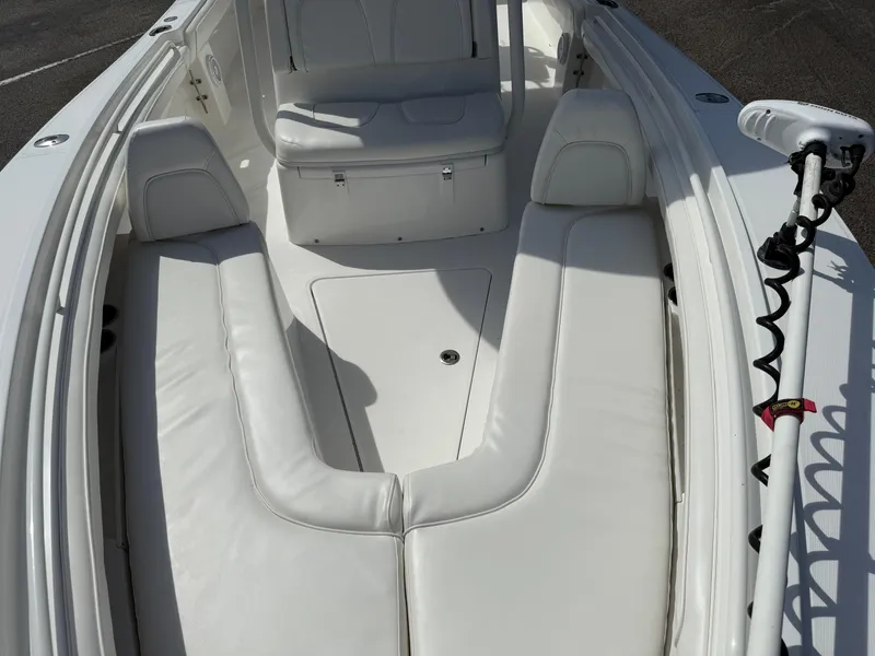 Slide: The Image of 2016 Regulator 23 boat interior with white cushioned seating and storage. - 21