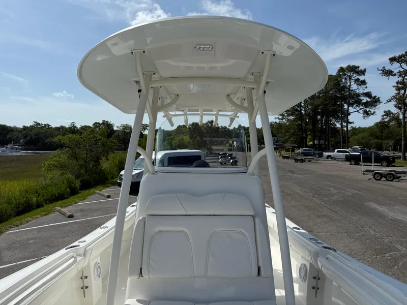 Slide: The Image of 2016 Regulator 23 boat with T-top, parked in a scenic outdoor setting. - 22