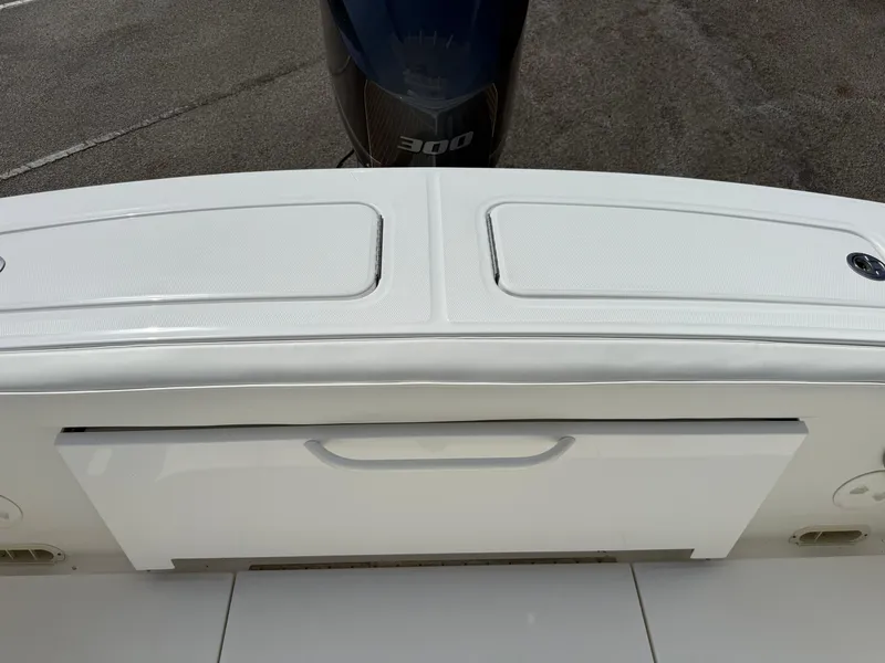 Slide: The Image of 2016 Regulator 23 boat stern with storage compartments and outboard motor. - 24