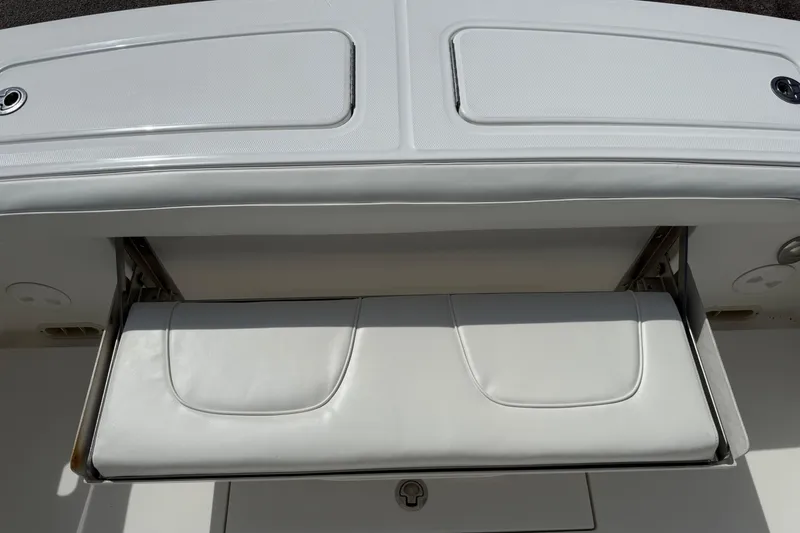 Slide: The Image of 2016 Regulator 23 boat with foldable white seat and storage compartment. - 25