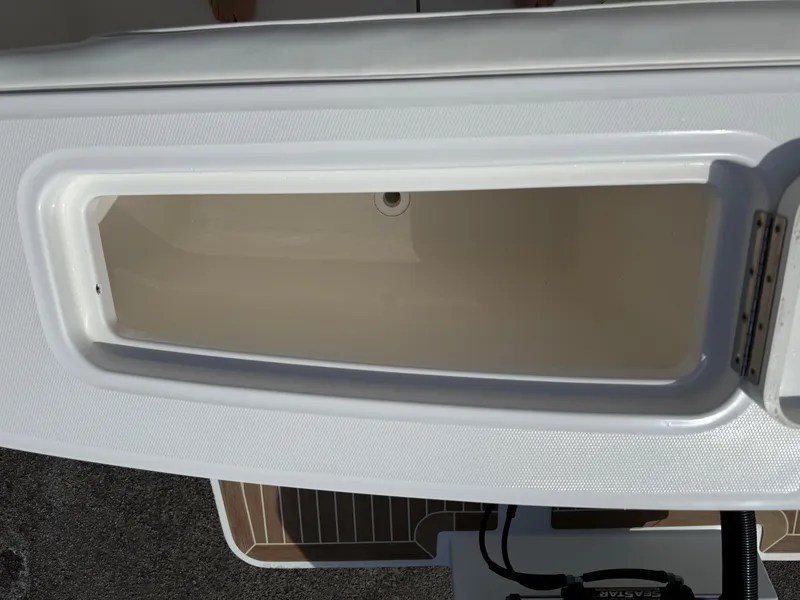 Slide: The Image of Open storage compartment on a 2016 Regulator 23 boat, showcasing interior space. - 27