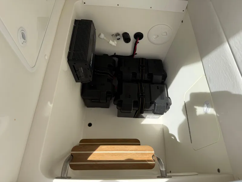 Slide: The Image of 2016 Regulator 23 boat battery compartment with multiple batteries and wiring. - 30