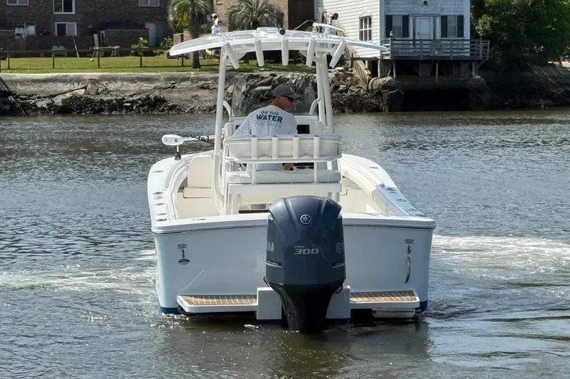 Slide: The Image of 2016 Regulator 23 boat with Yamaha 300 engine cruising on a calm waterway. - 4