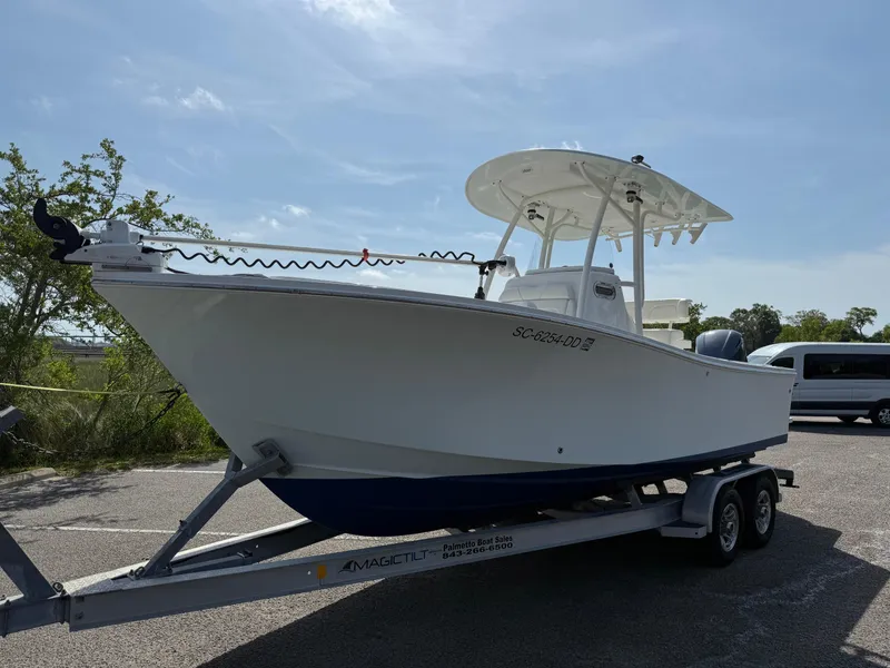 Slide: The Image of 2016 Regulator 23 boat on trailer, parked outdoors under clear sky. - 7