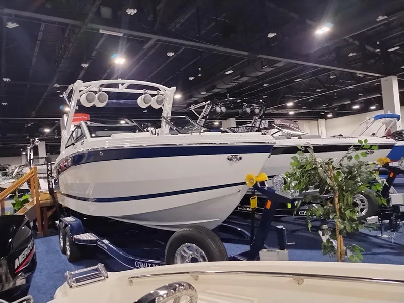 Slide: The Image of 2025 Cobalt R6 Surf boat displayed indoors at a boat show. - 1