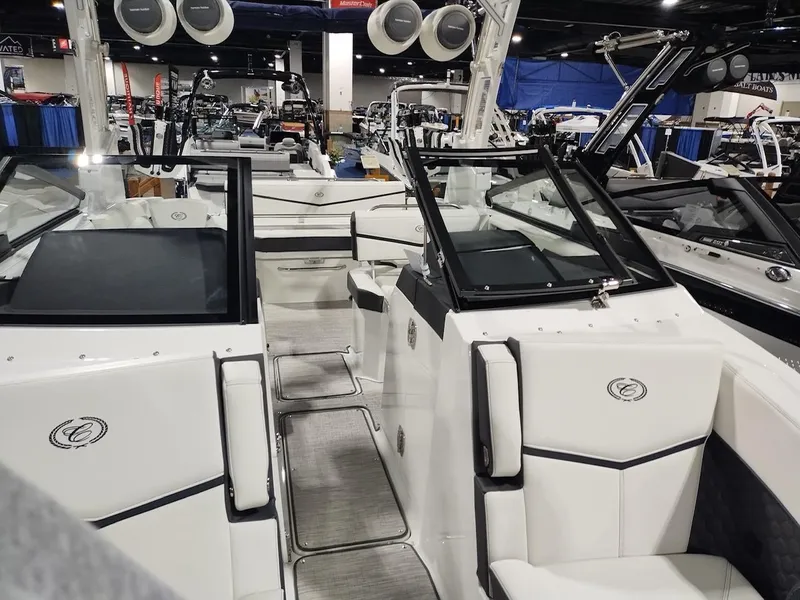 Slide: The Image of 2025 Cobalt R6 Surf boat interior with sleek white seating and modern design. - 13
