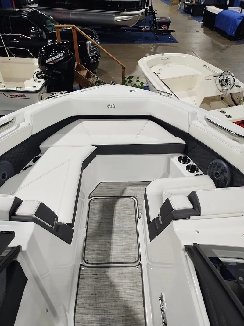Slide: The Image of 2025 Cobalt R6 Surf boat interior at a showroom, featuring sleek seating and modern design. - 14
