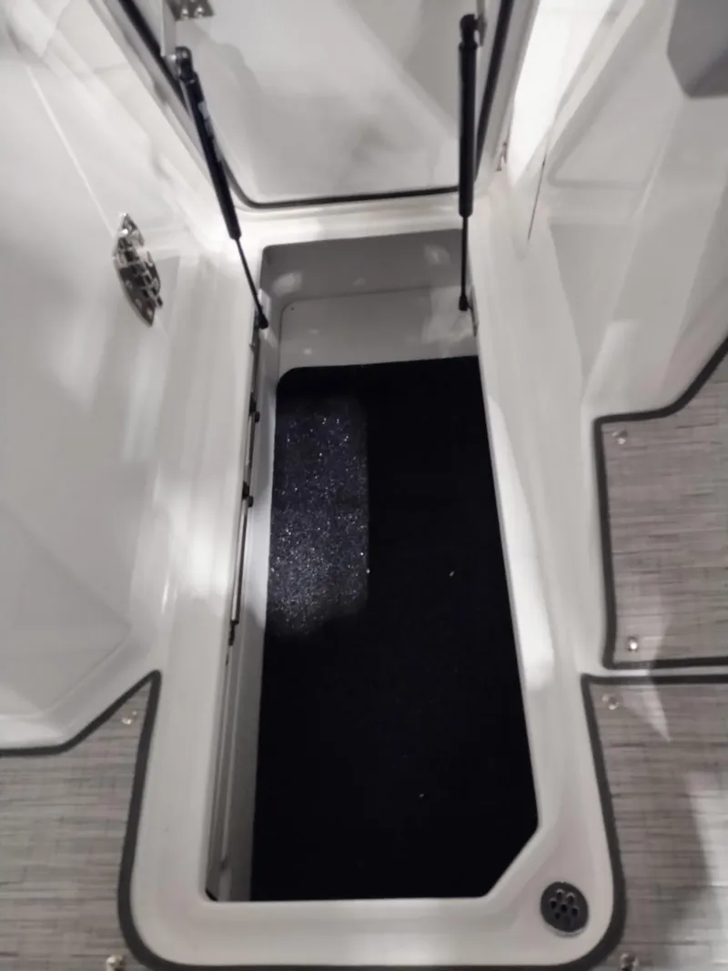 Slide: The Image of 2025 Cobalt R6 Surf storage compartment with open hatch, showcasing interior space and design. - 15