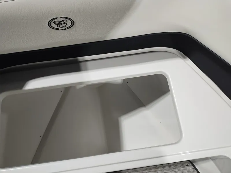 Slide: The Image of 2025 Cobalt R6 Surf boat interior storage compartment with logo detail. - 7